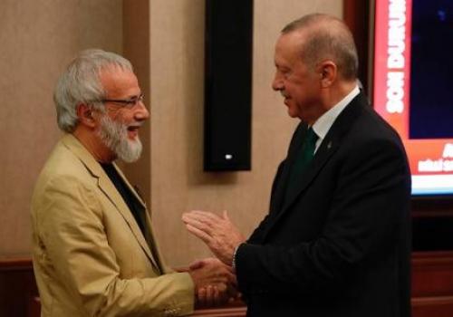 Recep Tayyip Erdogan (R) shakes hands with British singer-songwriter Yusuf Islam, formerly known as Cat Stevens (L), on 31 October 2019